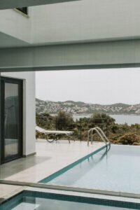 Modern villa pool area with stunning sea and mountain views in Antalya, perfect for relaxation.